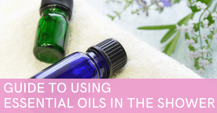 essential oil bottles and towel with text "Guide to Using Essential Oils in the Shower"