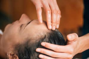 woman getting scalp massage with oil
