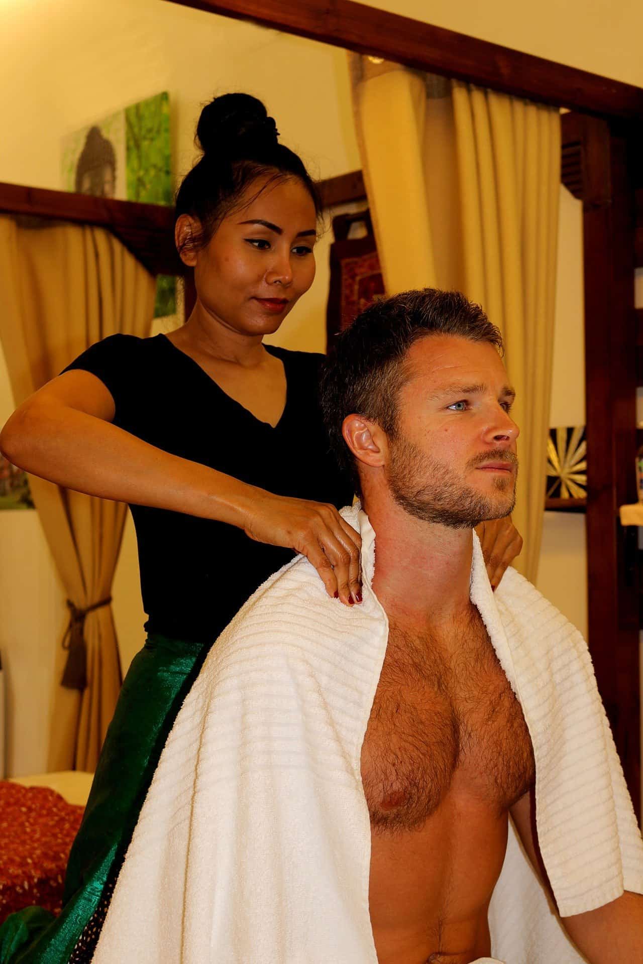 woman giving a man a thai massage